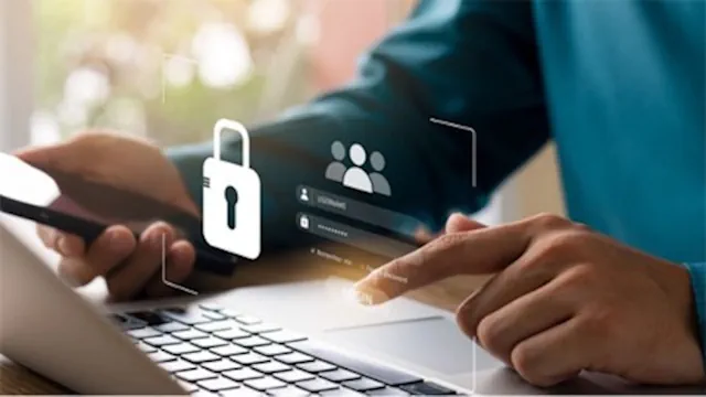 Business professional using a password manager to securely store, generate, and manage strong passwords across company accounts.